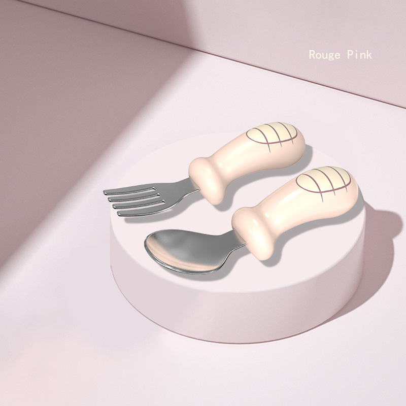 Baby pink cutlery with ergonomic silicone handles